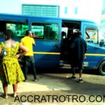 Trotro conductor looks out for passengers in Accra