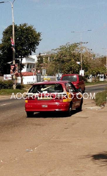 A taxi parks at the Danquah Circle trotro bus stop