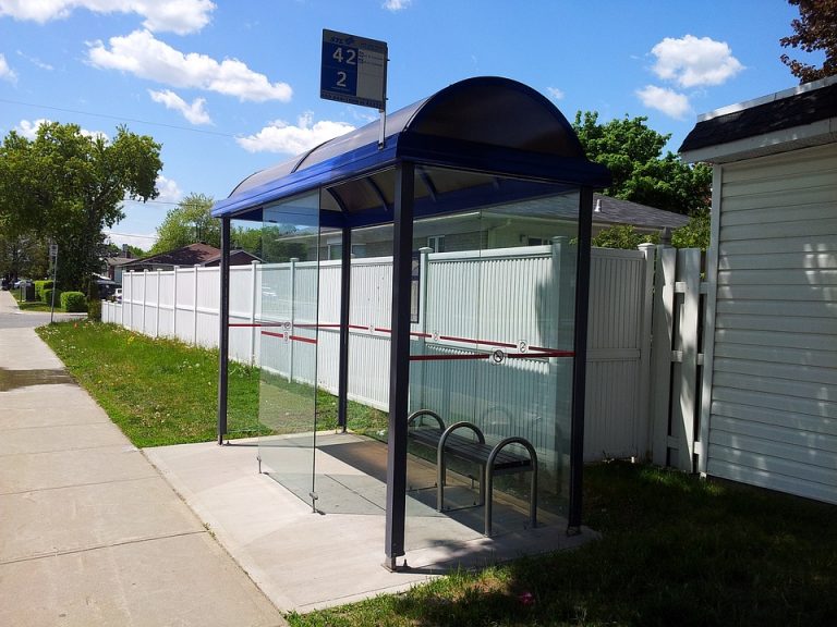 bus stop bus near a wall city