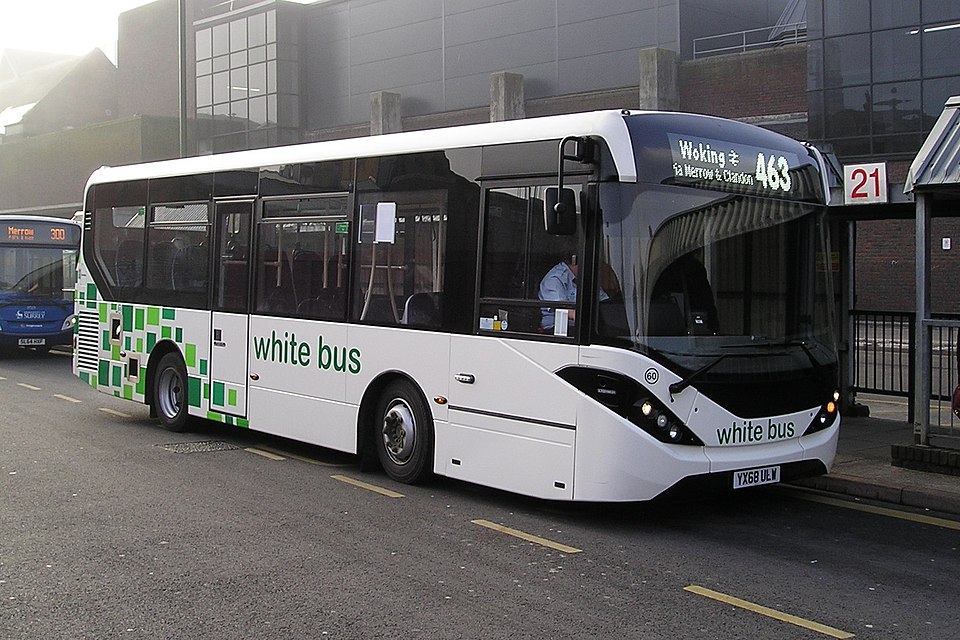 white-bus waits at a curb