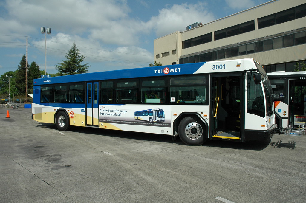 Show bus parked in front of a building in the city