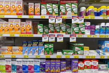 a pharmacy shelf stocked with drugs
