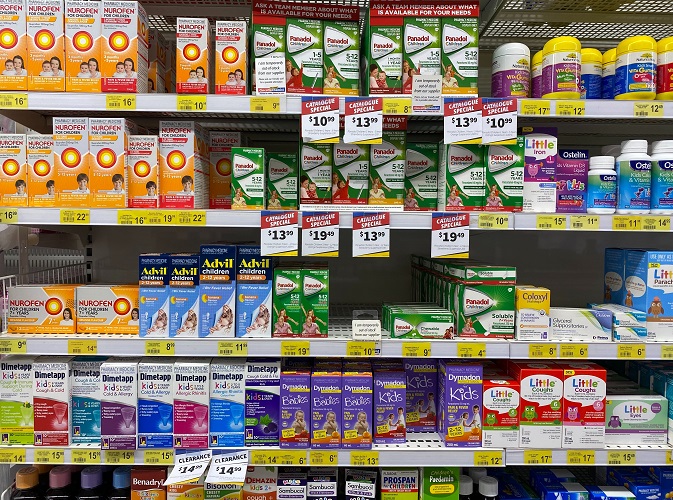 a pharmacy shelf stocked with drugs