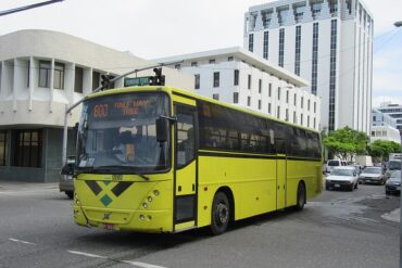 a transit bus passes a building