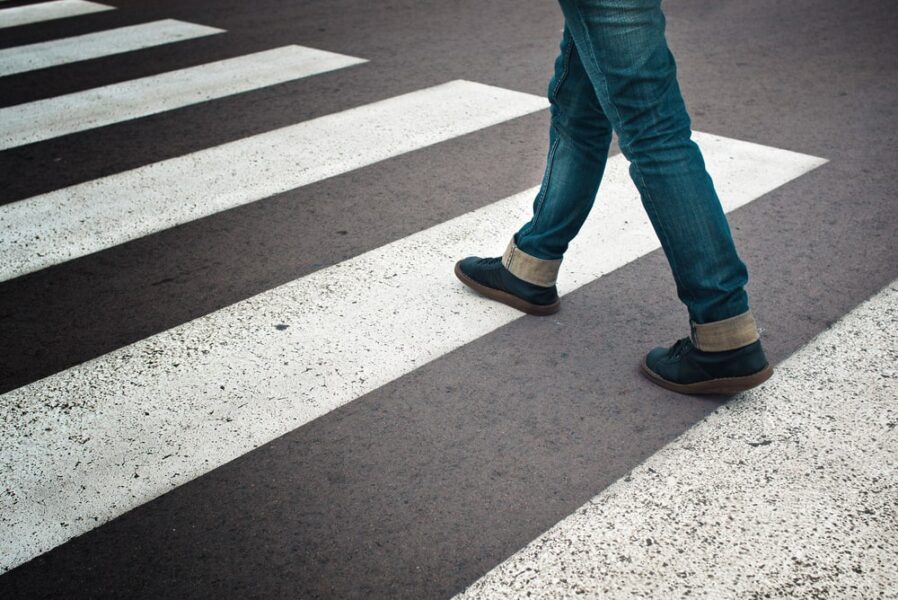 pedestrian steps on a cross walk