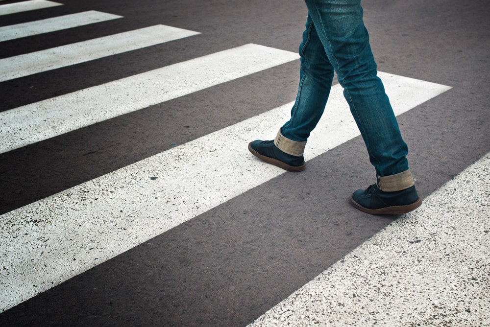 pedestrian steps on a cross walk