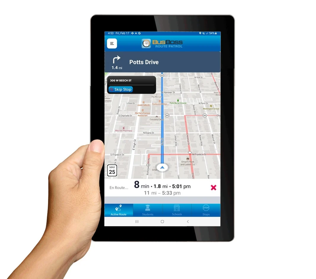 a woman holds a tablet showing a bus app