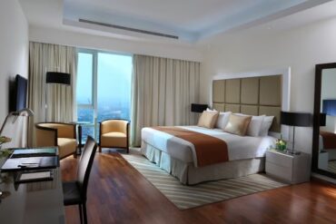 A hotel apartment showing bed and desk