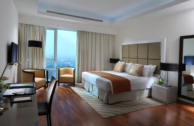 A hotel apartment showing bed and desk