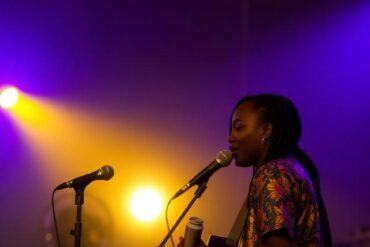 A singer playing a guitar in Ghana