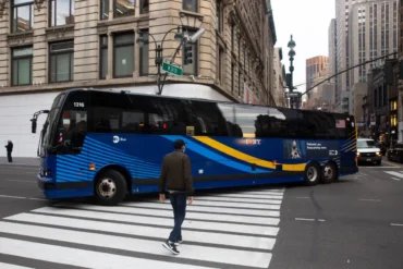 A Manhattan Express bus approaches a stop