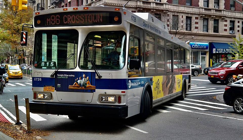 A city bus travels on the New York transit route