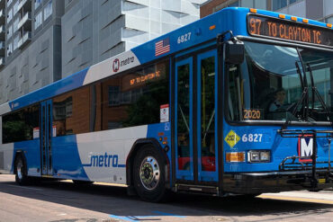 Commuters wait to board a municipal bus