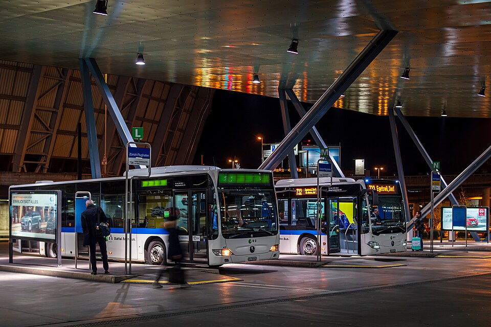 Vehicles park in bays at a bus station