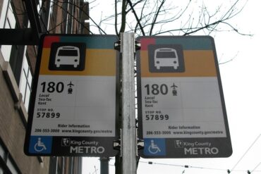 A bus stop with passenger notices