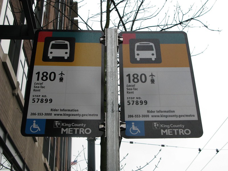 A bus stop with passenger notices
