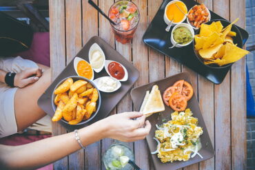 A woman eats snack from a bus station restaurant table