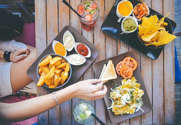 A woman eats snack from a bus station restaurant table