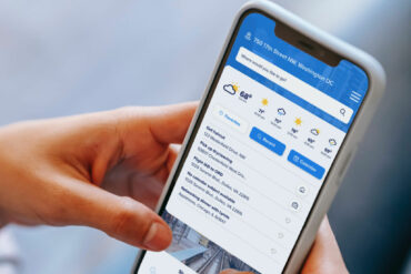 A woman operates a trip planner on her phone