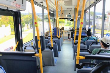 Passengers take their seats on a public transit bus