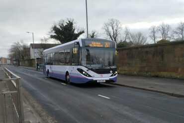 A Glasgow bus approaches the city
