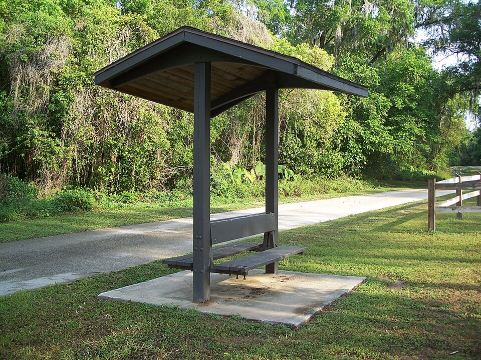 A bus bench under a shed