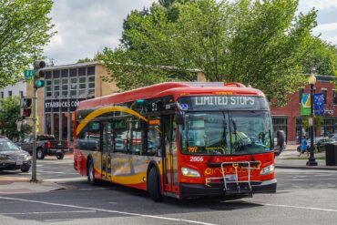 A bus turns the corner on a Washington DC street