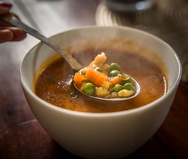 A ladle stirs Italian fish stew