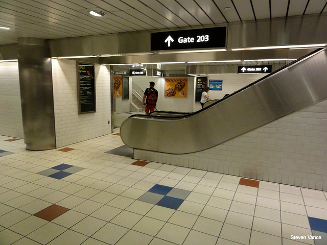 A passenger approaches the gate 203 of port authority bus station