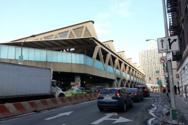 Vehicles approach a Manhattan bus station