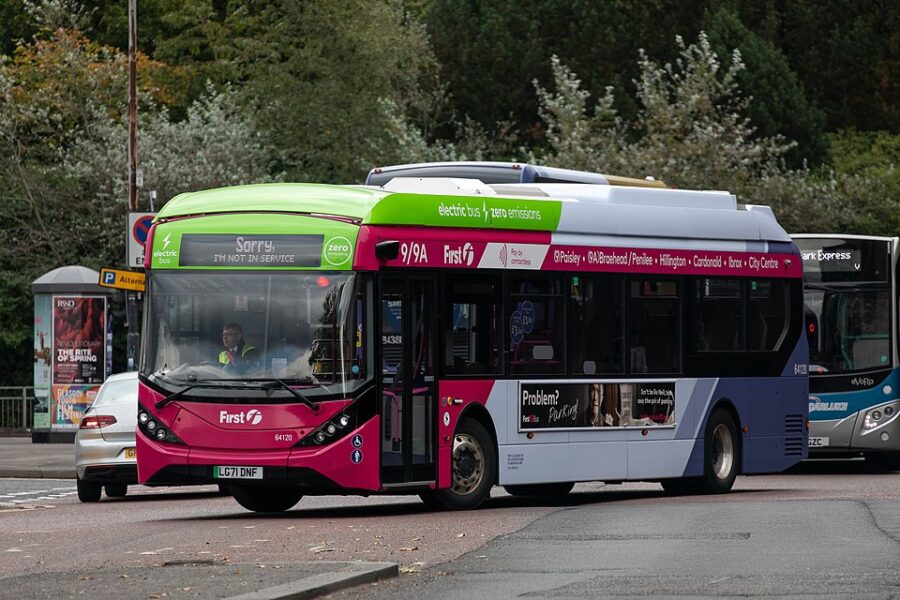 A GLASGOW CITY BUS APPROACHES A STOP