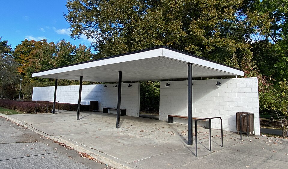 A bus shelter with a unique roof