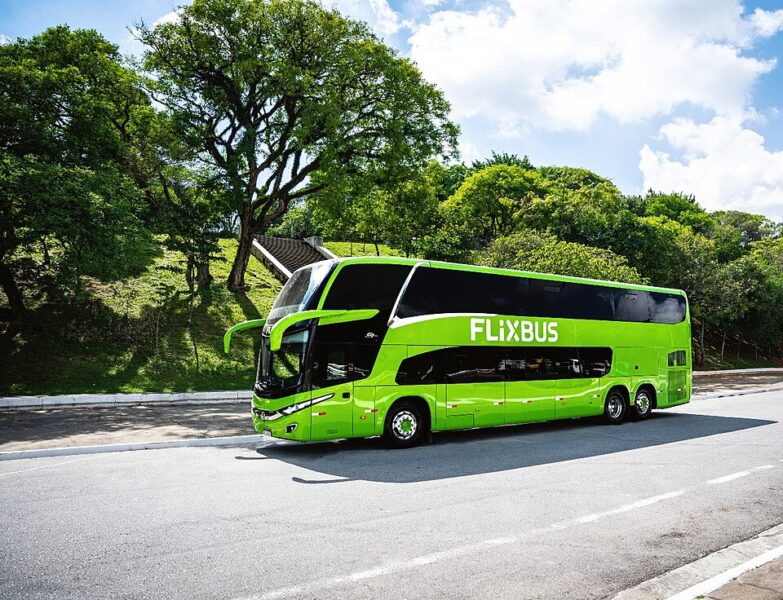A Flixbus travels the road in the countryside