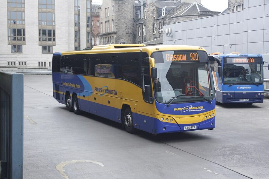 A Megabus 900 bus approaches a stop