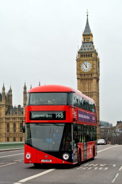 A London bus drives past the Big Ben