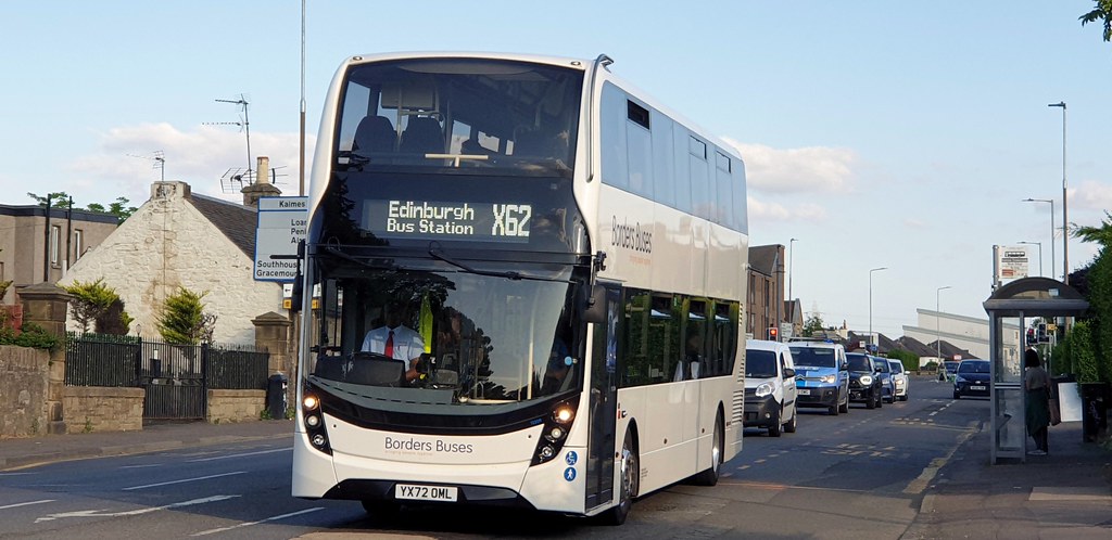 An X62 bus travels in traffic